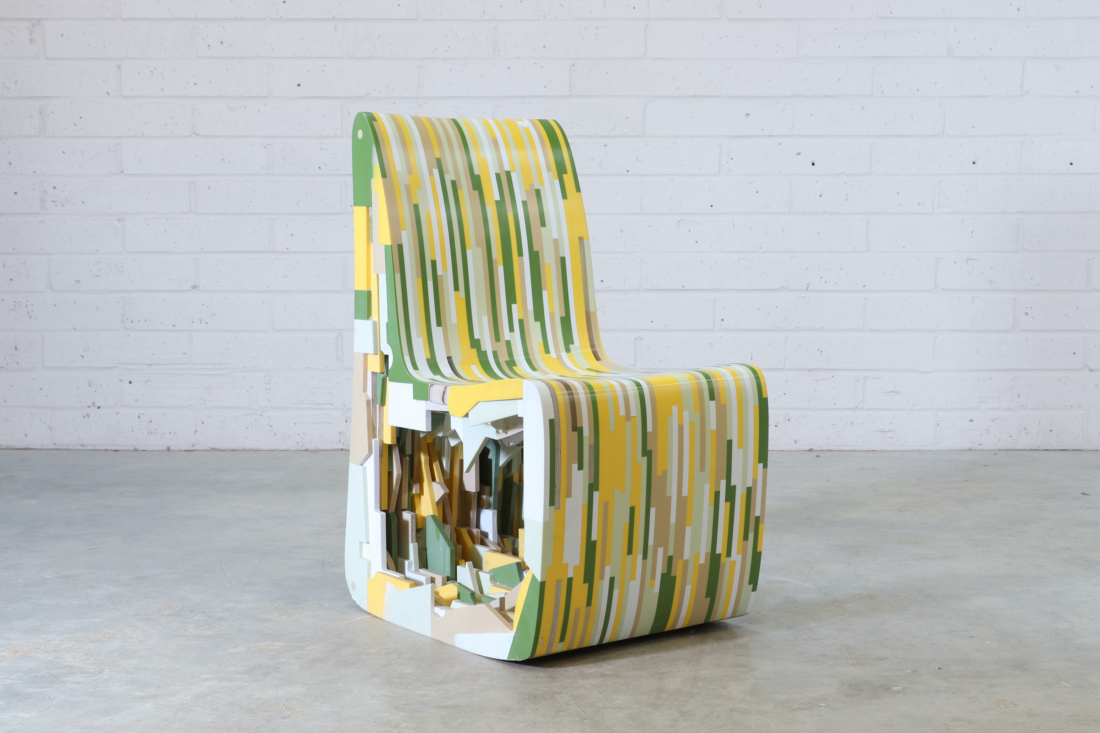 a 'Corian Chair', 2012, designed as part of the 'Leftover Collection', the Corian frame finished in yellow, green, and white (£300-500)