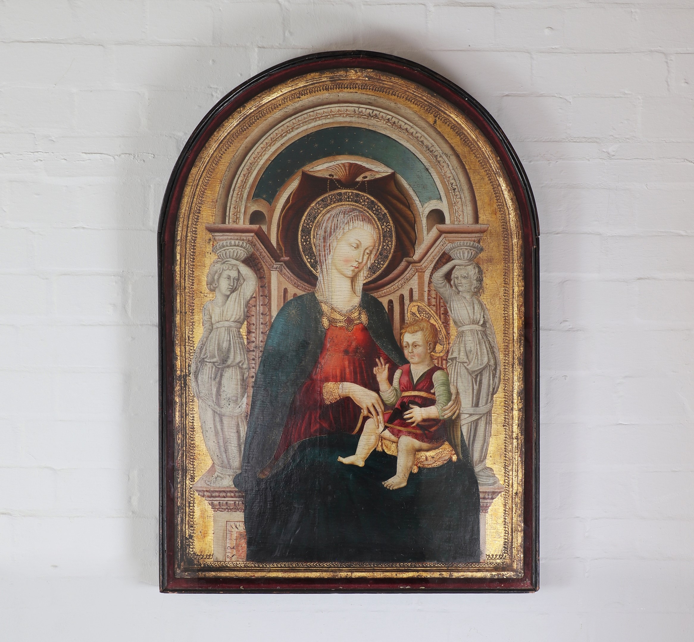Follower of Neri di Bicci (Italian, 1418-1492) Madonna and Child enthroned egg tempera on panel with later oil additions, gilding and punchwork to the decorated edge and halo, arched top 88 x 62cm, within an integral frame (Sold for £20,800)