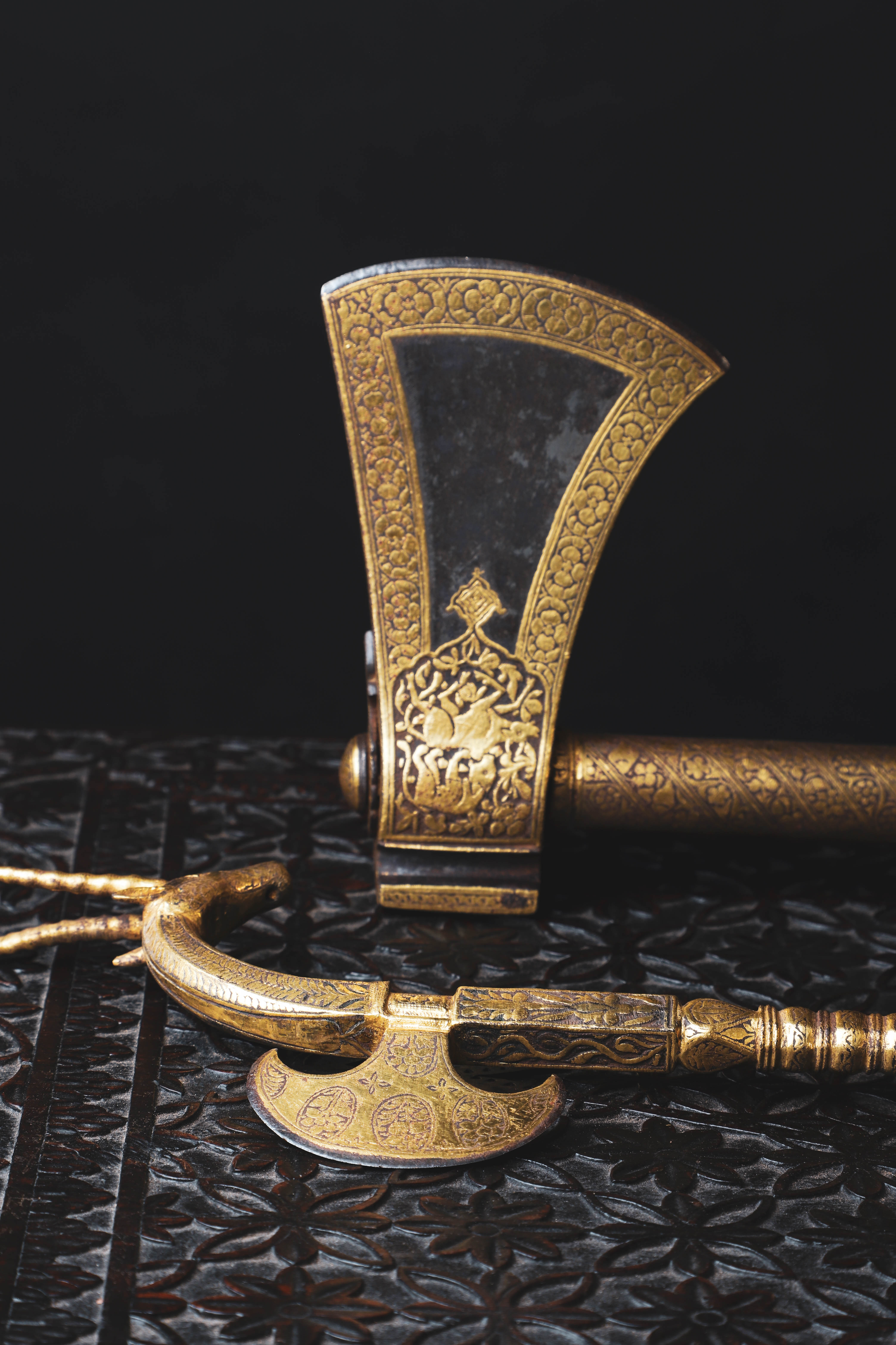 A Mughal Deccan koftgari 'tabarzin' saddle axe (£3,000-5,000) and an Indian Deccan ceremonial koftgari axe (£5,000-10,000)