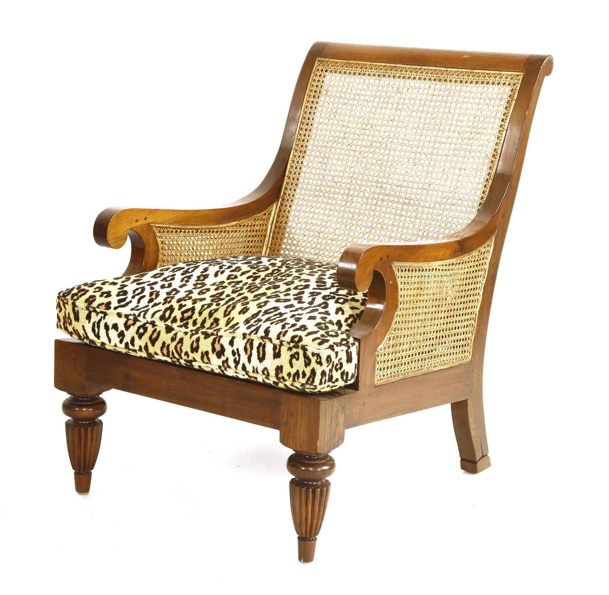 A teak chair with faux leopard cushion cover