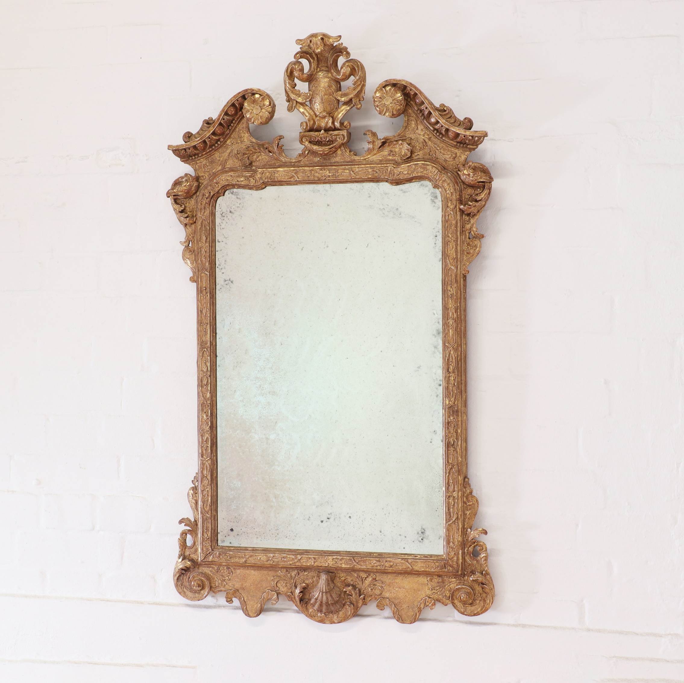 A George II carved giltwood and gesso pier mirror, second quarter of the 18th century and later
