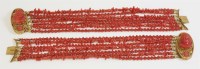 Lot 301 - A pair of seven row coral bead bracelets