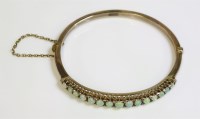 Lot 314 - An Edwardian opal and diamond gold hinged bangle