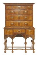 Lot 517 - A walnut and feather strung chest on stand