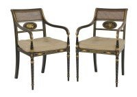 Lot 394 - A pair of Regency-style ebonised and gilt open armchairs