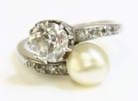 Lot 342 - An Art Deco pearl and diamond crossover ring with diamond set shoulders