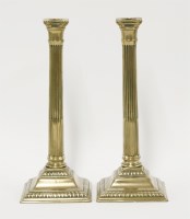 Lot 80 - A pair of George III bell metal neoclassical candlesticks