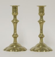 Lot 113 - A pair of George III brass ejector candlesticks