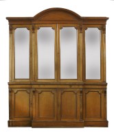 Lot 343 - A Victorian light oak breakfront bookcase
with an arched cornice and glazed upper doors