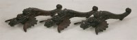 Lot 1174 - Three carved wood 'flying fish' ornamental wall hangings