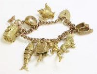 Lot 1025 - A gold curb link charm bracelet