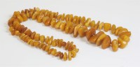 Lot 324 - A single row of graduated freeform 'butterscotch' amber beads
