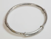 Lot 1014 - A white gold paste set bangle