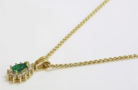 Lot 1015 - A pear shaped emerald and diamond gold cluster pendant