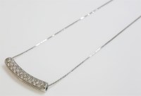 Lot 1016 - A white gold curved bar slider pendant