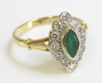 Lot 1018 - An 18ct gold emerald and diamond marquise shaped cluster ring