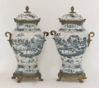 Lot 1105 - A pair of Chinese style vases and covers