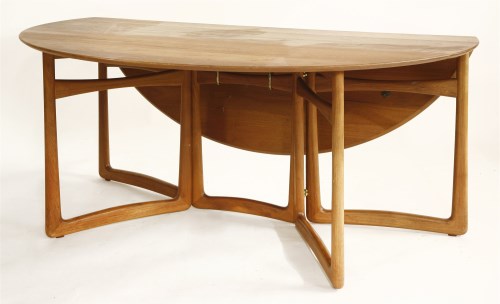 Lot 685 - A teak circular drop-leaf dining table