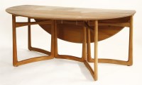 Lot 685 - A teak circular drop-leaf dining table