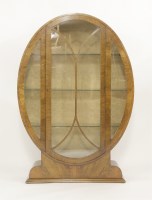 Lot 169 - An Art Deco walnut oval display cabinet