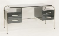 Lot 231 - An ebonised and chrome desk
