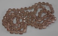 Lot 20 - A single row uniform faceted pink glass bead necklace