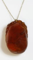 Lot 330 - A Chinese carved amber pendant