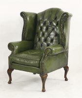 Lot 1607 - A Queen Anne style scroll wing armchair