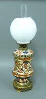 Lot 1163 - A late 19th century 'imari' design pottery vase oil lamp