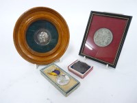 Lot 1044 - An oak framed silver metal medallion of a young Queen Victoria
