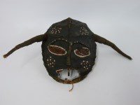 Lot 1235 - An African cloth and wood mask