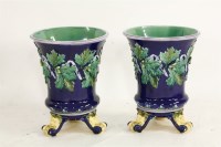 Lot 1073 - A pair of majolica jardinières on stands