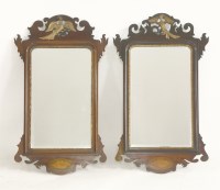 Lot 1551 - A pair of 18th century style walnut fret frame wall mirrors