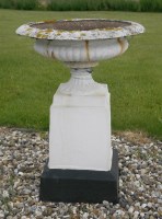 Lot 1676 - A pair of white painted cast iron garden urns