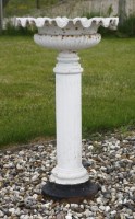 Lot 1677 - A pair of white painted cast iron garden urns