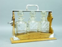 Lot 1237 - A late Victorian oak three bottle tantalus