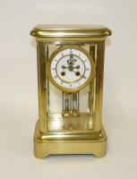 Lot 1317 - An Edwardian brass four glass mantel clock