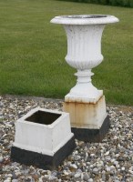 Lot 1675 - A pair of white painted cast iron garden urns