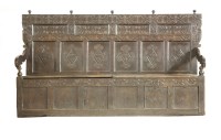 Lot 394 - A carved oak settle