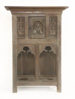 Lot 398 - A carved oak cupboard