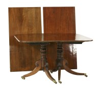 Lot 552 - A mahogany twin pillar dining table