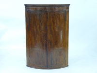 Lot 1500 - A George III strung mahogany bow front corner cabinet