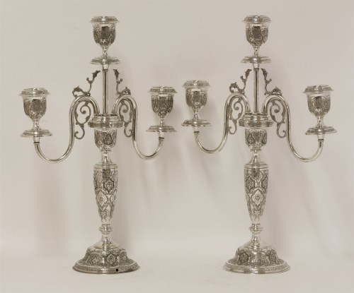 Lot 16 - A pair of Persian metalwares three light candelabra