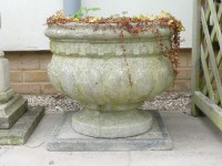 Lot 790 - A large pair of reconstituted stone garden urns