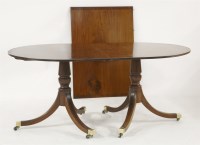 Lot 633 - A Redman & Hales mahogany twin pillar dining table