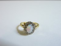 Lot 50 - An 18ct gold opal and diamond oval cluster ring