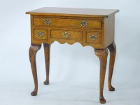 Lot 669 - A reproduction burr wood lowboy