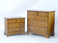 Lot 670 - A reproduction burr walnut chest of drawers