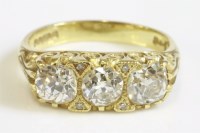 Lot 307 - An 18ct gold three stone diamond carved head ring