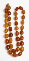 Lot 339 - A single row amber and wooden rondelle bead necklace